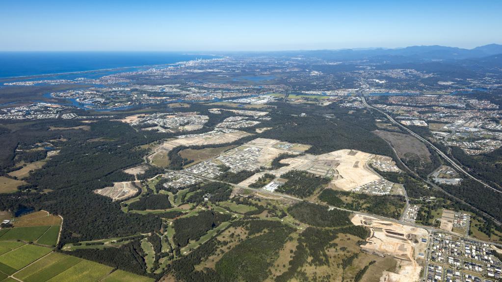 An aerial shot of Pimpama showing the Coasts northern growth suburb and cleared land for residential estates on the western side of the M1 looking south to Surfers Paradise.
